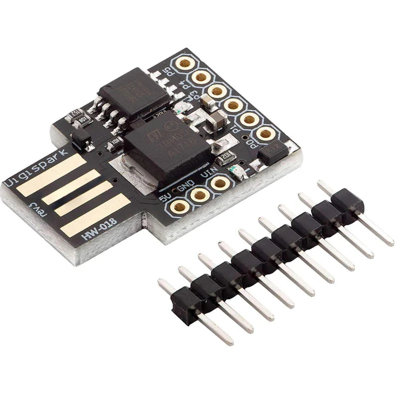 A Digispark ATTINY85 USB Development Board featuring a black microcontroller board with a set of pins and a USB connector.